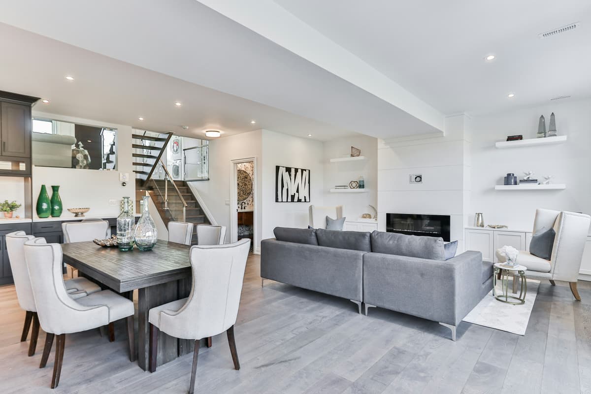 Open-plan dining and living space with white ceilings and gloss-finished woodwork